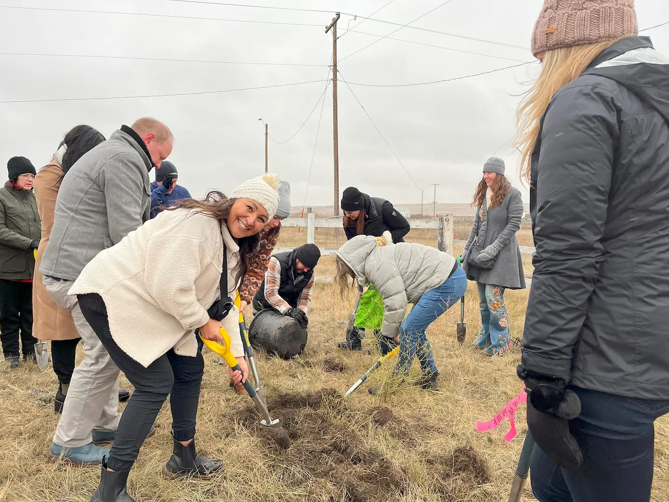 Volunteers planting trees at Siksika Nation community event